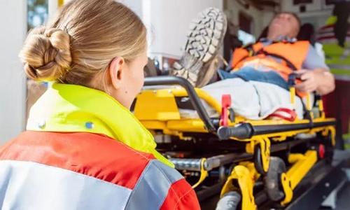 EMT Paramedic with Diploma in Birmingham Loading Patient Into Ambulance